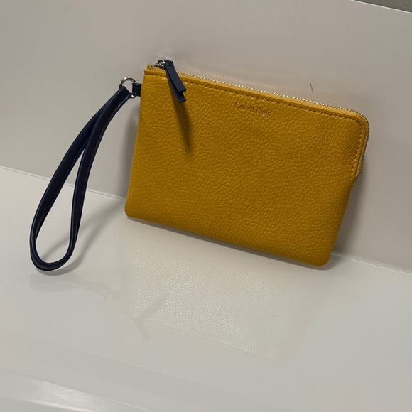 Calvin Klein Handbags - Calvin Klein Mustard Wristlet Clutch